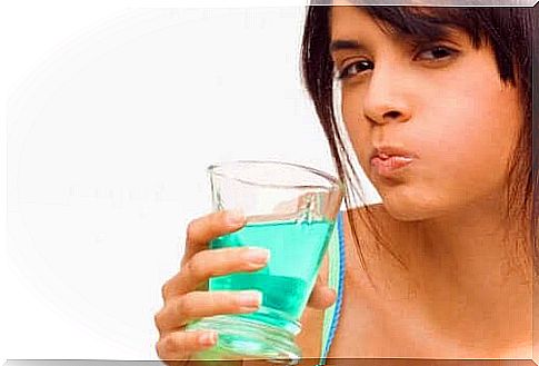 Woman uses mouthwash with chlorhexidine