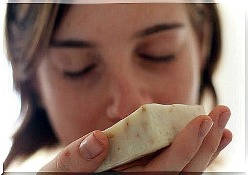 Hand holds a bar of homemade soap