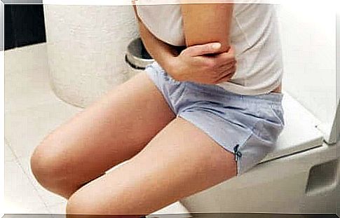 Indestructive sluggishness: woman sits on the toilet in pain