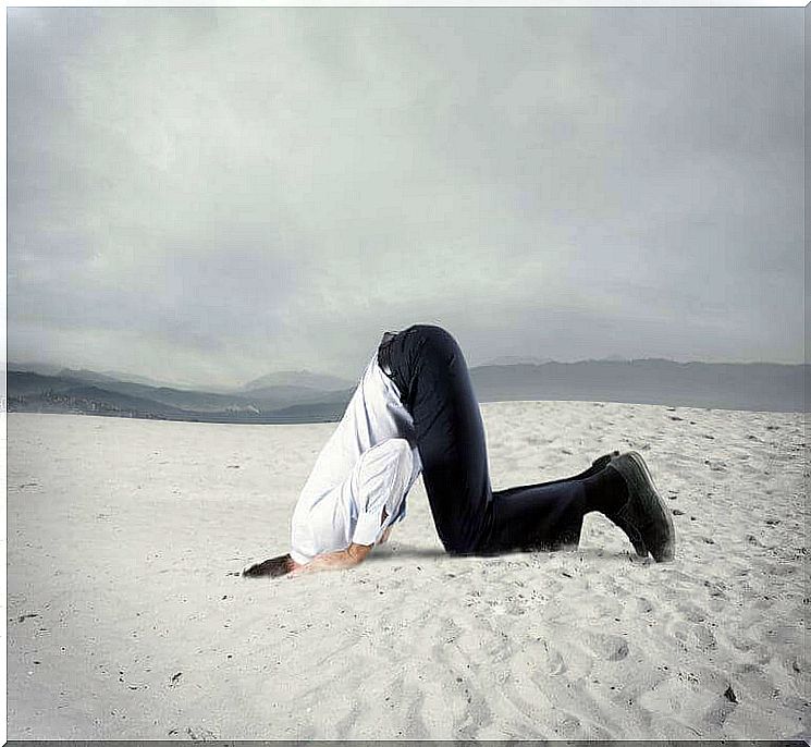 Man bears his head in the sand because he has unsolved problems