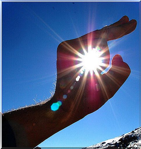 Hand, blue sky and blue light