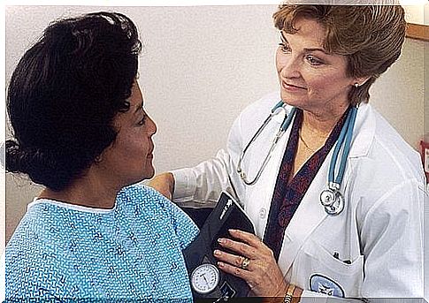 Female doctor measures blood pressure